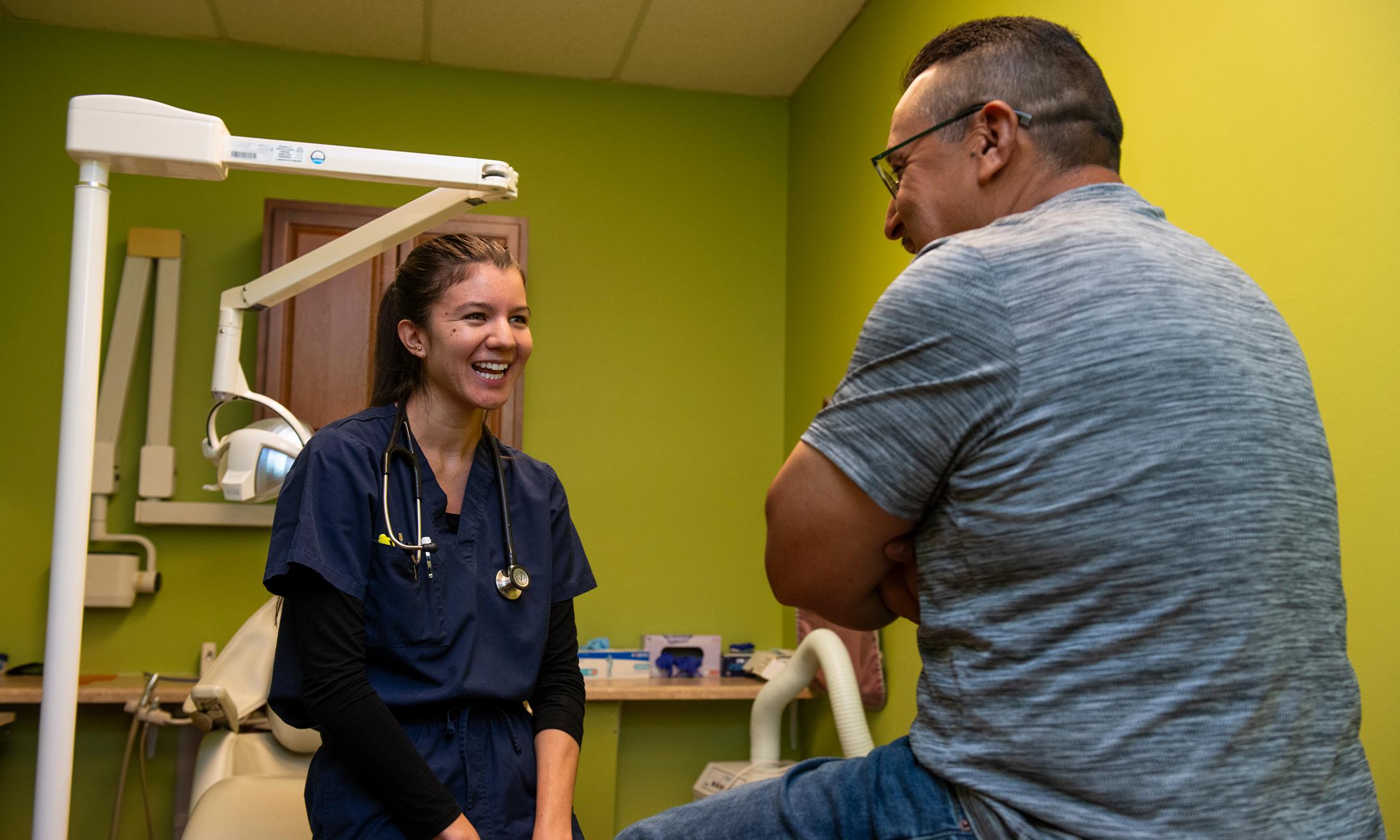 An image of an OUWB student and patient talking